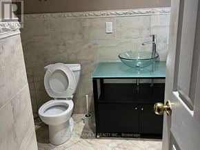 Toronto (Dovercourt-Wallace Emerson-Junction) apartment for rent - A bathroom with a toilet, a sink, and a cabinet.