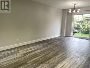 Milton (Bm Bronte Meadows) apartment for rent - A room with wooden flooring and a sliding glass door leading to a garden.