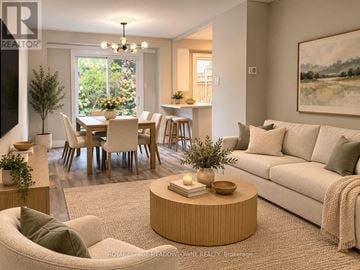 Milton (Bm Bronte Meadows) apartment for rent - A living room with a white couch, a wooden coffee table, and a dining table with chairs.