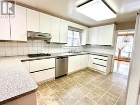 Toronto (Bayview Woods-Steeles) apartment for rent - A kitchen with white cabinets and a tiled floor.