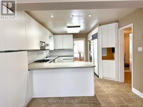 Toronto (Bayview Woods-Steeles) apartment for rent - A kitchen with white cabinets and a countertop.