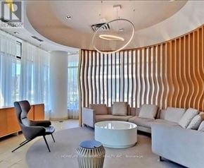Toronto (Don Valley Village) condo for rent - A modern living room with a curved wall and a circular light fixture.