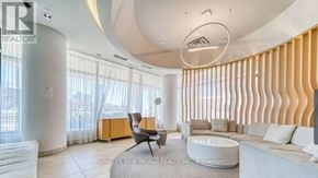 Toronto (Don Valley Village) condo for rent - A modern living room with a curved ceiling and a large window with vertical blinds.
