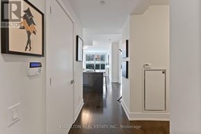 Toronto (Annex) condo for rent - A hallway with a Real Estate Inc. sign on the wall.