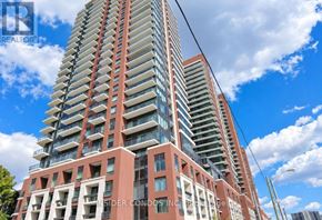 Toronto (Humber Heights) condo for rent - A tall red and white building with many windows and balconies.