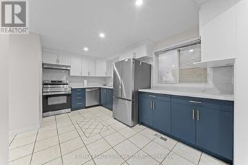 Cambridge apartment for rent - A kitchen with blue cabinets and a white refrigerator.