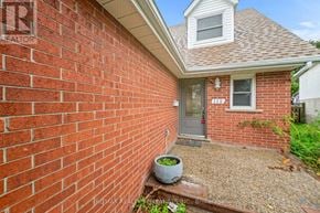 Cambridge apartment for rent - A red brick house with a grey door and a window.