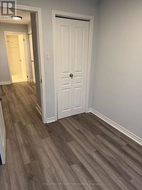 Toronto (Humewood-Cedarvale) apartment for rent - A white door is in a room with wood flooring.
