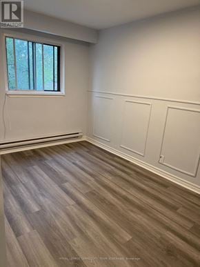 Toronto (Humewood-Cedarvale) apartment for rent - A room with wooden flooring and white walls.