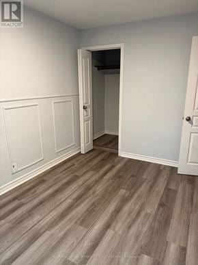 Toronto (Humewood-Cedarvale) apartment for rent - A room with a wooden floor and white walls.