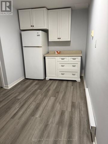 Toronto (Humewood-Cedarvale) apartment for rent - A kitchen with a white fridge, cabinets and drawers.
