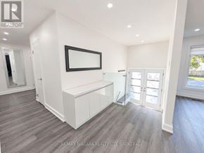 Oakville (Wo West) duplex for rent - A spacious room with a white cabinet and a framed picture on the wall.
