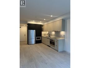 North Vancouver apartment for rent - A modern kitchen with a refrigerator, oven, and stove.