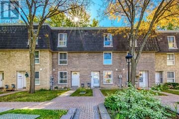 Toronto (Bayview Village) townhouse for rent - A brick building with a green lawn in front.