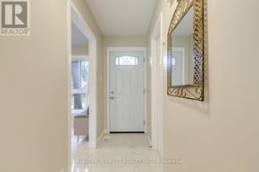 Toronto (Bayview Village) townhouse for rent - A hallway with a white door and a mirror on the wall.
