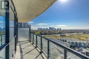 Mississauga (Hurontario) condo for rent - A balcony with glass railings overlooks a city skyline.