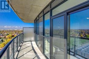 Mississauga (Hurontario) condo for rent - A balcony with glass doors overlooking a cityscape.