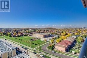 Mississauga (Hurontario) condo for rent - A brokerage firm's logo is visible in the upper left corner of an aerial view of a residential area with houses, trees, and a road.