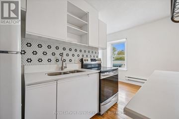 Centre Wellington (Elora/Salem) apartment for rent - A kitchen with a sink, stove and a window.