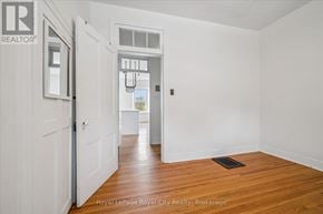 Centre Wellington (Elora/Salem) apartment for rent - A white door is open to a hallway with a wooden floor.