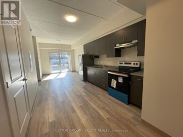 London South (South J) condo for rent - A kitchen with wood flooring and a refrigerator.