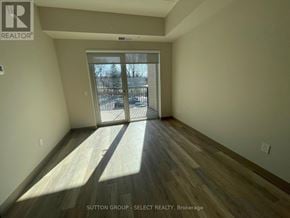 London South (South J) condo for rent - A room with wooden flooring and a sliding glass door leading to a snowy landscape.