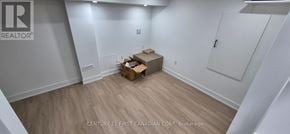 London South (South V) townhouse for rent - A room with wooden flooring and white walls, with a cardboard box on the floor.