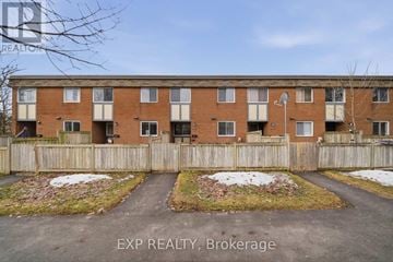 Ottawa townhouse for rent - A building with the text EXP REALTY, Brokerage in the foreground.