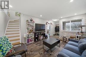 Ottawa townhouse for rent - A living room with a couch, a coffee table, and a staircase.