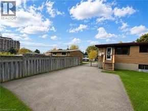 London apartment for rent - A realtor photo of a residential area with houses and a fence.