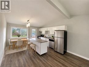 London apartment for rent - A kitchen with a refrigerator, stove, and dining table.