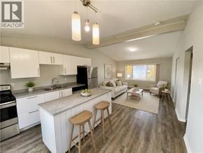 London apartment for rent - A well-lit kitchen with white cabinets and a wooden island.