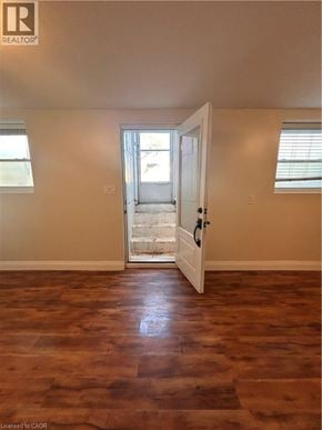 Hamilton apartment for rent - A room with a wooden floor and a door leading to a balcony.