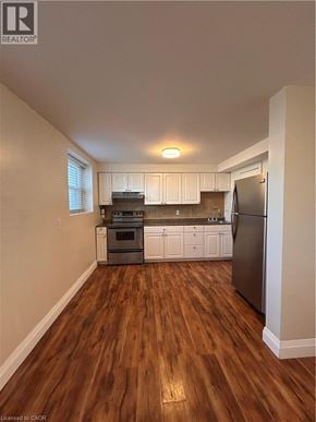 Hamilton apartment for rent - A kitchen with a refrigerator, oven, and cabinets.