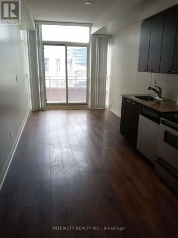 Toronto (Niagara) condo for rent - A kitchen with a sink and a stove top oven.
