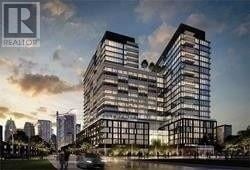 Toronto (Moss Park) condo for rent - A modern multi-story building with a glass facade is depicted in the image.