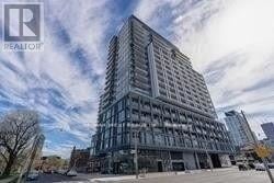 Toronto (Moss Park) condo for rent - A tall building with many windows is under construction.