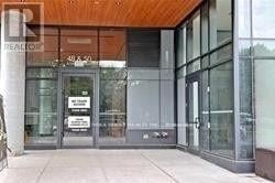 Toronto (Moss Park) condo for rent - The image shows the front of a building with a glass door and a sign that reads "REALTOR".