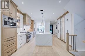 Burlington (Lasalle) apartment for rent - A modern kitchen with wooden cabinets and a marble island.