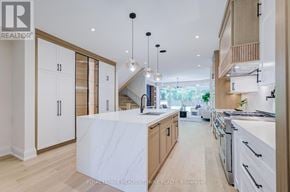 Burlington (Lasalle) apartment for rent - A modern kitchen with white marble countertops and wooden cabinets.