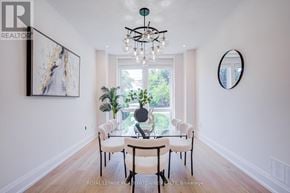 Burlington (Lasalle) apartment for rent - A dining room with a white table and chairs, a chandelier, and a large window.