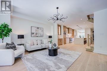 Burlington (Lasalle) apartment for rent - A well-lit, spacious living room with a white sofa and a large chandelier.