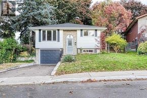 Hamilton (Gilkson) apartment for rent - A house with a grey garage door is for sale.