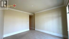 West Vancouver apartment for rent - A room with a carpeted floor and a doorway leading to another room.