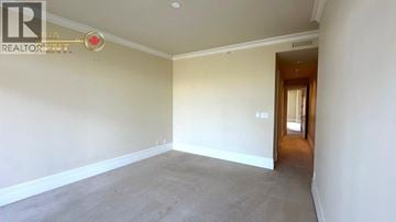 West Vancouver apartment for rent - A spacious room with a carpeted floor and white walls.