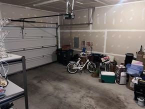 Surrey apartment for rent - A garage with a bicycle, a cooler, and a few boxes.