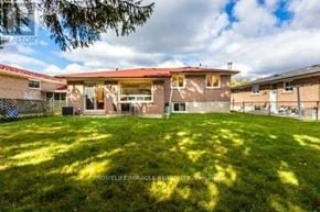 Toronto (Woburn) apartment for rent - A sunny day at a residential area with houses and green lawns.