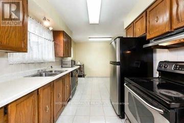 Toronto (Woburn) apartment for rent - A kitchen with wooden cabinets and black appliances.