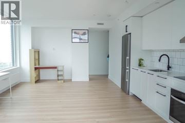 Burnaby apartment for rent - A kitchen with white cabinets and a wooden floor.