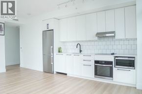 Burnaby apartment for rent - A white kitchen with a refrigerator, oven, and sink.